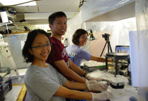 Jong-Mi Lee, Yang Xiang and Phoebe Lam of UC Santa Cruz process samples in their “Bubble” on board the Oceanus. 